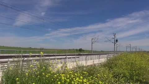 High speed train over yellow flowers Stock Footage 70683467