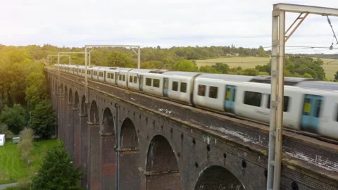 High-speed train passes an arched railway bridge. Aerial drone footage. Stock Footage 211810685