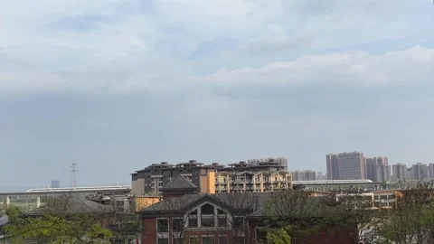 High Speed Train Passing Behind Modern Residential Apartment Complex in Chin Stock Footage 334840868