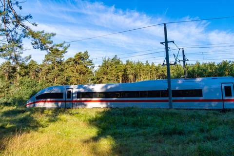 High-Speed Train Passing Forest Edge Stock Photos