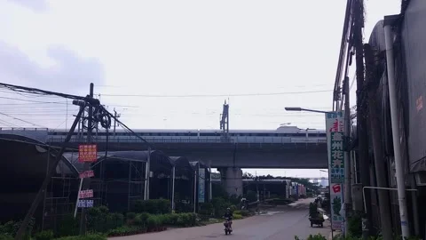 A high speed train passing over a road in a plant warehousing area, China,4K Video stock 282965319
