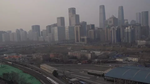 A high-speed train running past Beijing's central business area Stock Footage 234370899
