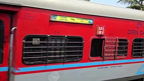 High speed train window perspective racing past a stationary orange sleeper trai Stock-Footage 341349112