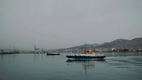 High-speed vessel serving ships sailing in the Gulf of an industrial city Stock Footage 88837934