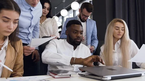 High-spirited 30s mixed races office managers working together under their Stock Footage 117472698