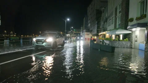 High spring tide causes flooding to town seafront at St Peter Port, Guernsey Stock Footage 254410403