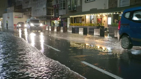 High spring tide causes flooding to town seafront at St Peter Port, Guernsey Stock Footage 254410457