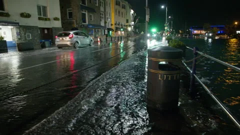 High spring tide causes flooding to town seafront at St Peter Port, Guernsey Stock Footage 254410546