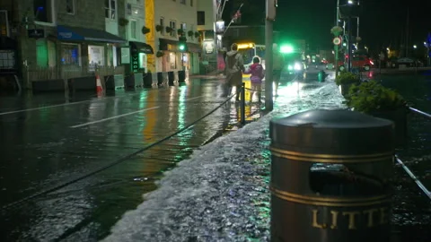High spring tide causes flooding to town seafront at St Peter Port, Guernsey Stock Footage 254410565