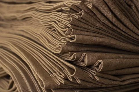 A high stack of brown fabric , Stock Photos