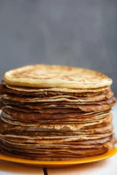 High stack of classic Russian thin pancakes. Rustic style. Traditional for the Stock Photos
