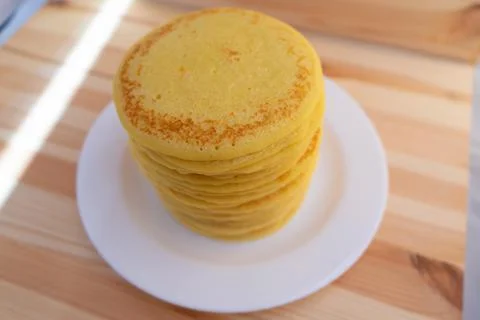 High stack of home-made pancakes on white plate. Breakfast for the whole family Stock Photos
