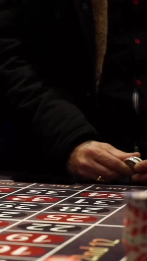 High stakes gambling action in a lively casino at night with roulette and chips 스톡 동영상 321378187