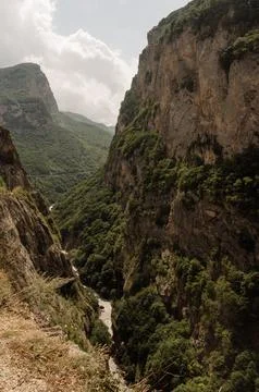 High steep cliffs covered with vegetation and a river Stock Photos