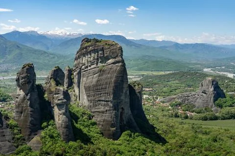 High steep rock formations and towns in between  in forest and snow mountains Stock Photos
