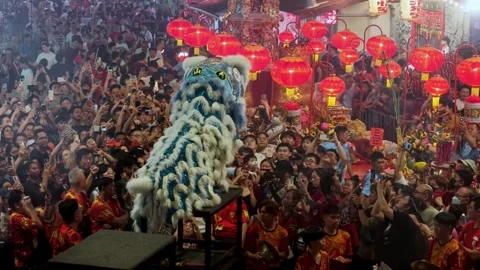 High stilt lion dancers perform acrobatics in aerial night scene Stock Footage 327809692