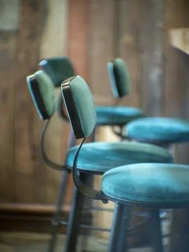 High stools aligned in front of the counter of a restaurant Stock Photos