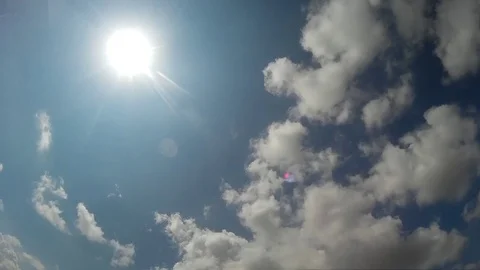 High sun in the clouds of the blue sky Stock Footage 115833208