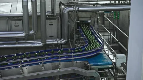 A high-tech bottling plant with an automated conveyor system transports green Video stock 307276815