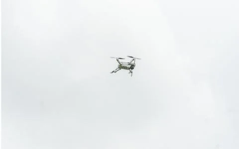 A high-tech drone in the sky Professional filming drone flies in the air at a Stock Photos