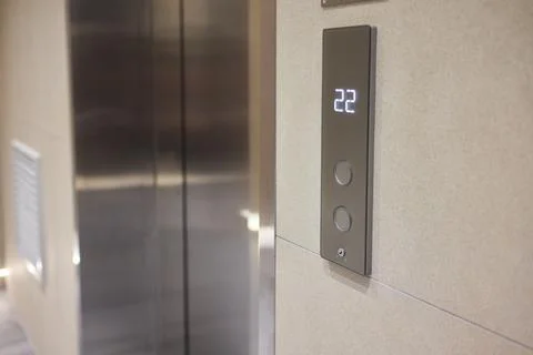 High-tech elevator panel featuring tactile buttons and illuminated screen Stock Photos