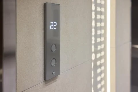High-tech elevator panel featuring tactile buttons and illuminated screen Stock Photos