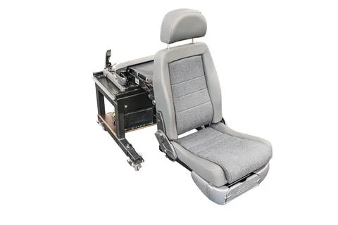 High-tech industrial setup featuring a modified car seat on a mechanical pl.. Stock Photos