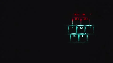 High tech keyboard with flickering dancing LED lights in the dark Stock Footage 154335594