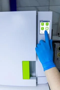 High-Tech Laboratory Refrigerator in Use: Hand in Blue Glove Selecting Settings Foto stock