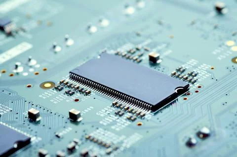 High-tech microchip on an electrical circuit board close-up Stock Photos