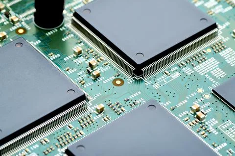 High-tech microchips on an electronic board close-up Stock Photos