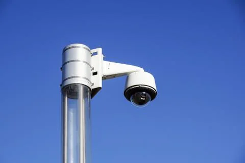 High tech overhead security camera with a blue sky Stock Photos