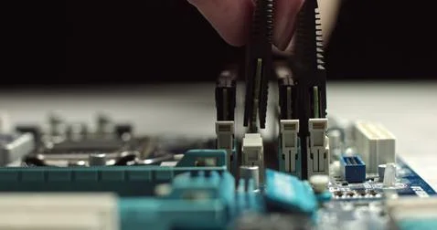 High tech. The process of installing RAM on a computer motherboard. Close-up 4K Stock Photos