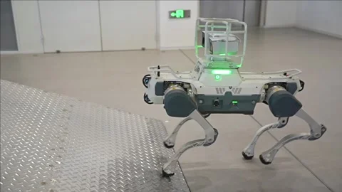 High tech quadruped robot with advanced mobility stepping towards a metal Stock Footage 328988449