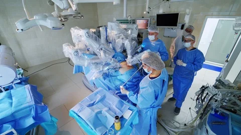 High-tech surgery with robotic equipment. Medical team performing an operation Stock Footage 130015471
