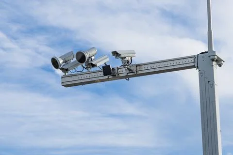 High-tech traffic enforcement cameras mounted on a gantry for speed control a Stock Photos