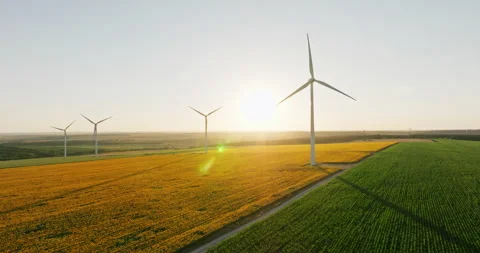High-tech wind turbines generate clean energy over rural fields Stock Footage 301893513
