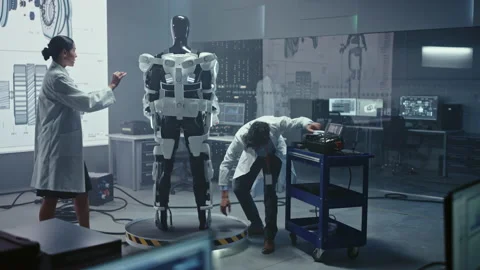 High Technology Research Laboratory Scientists and Engineers Testing Exoskelet Stock Footage 136593733