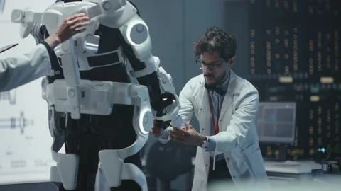 High Technology Research Laboratory Scientists and Engineers Testing Exoskelet Stock Footage 136594056