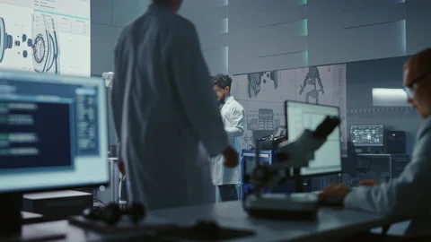 High Technology Research Laboratory Scientists and Engineers Testing Exoskelet Stock Footage 136594204