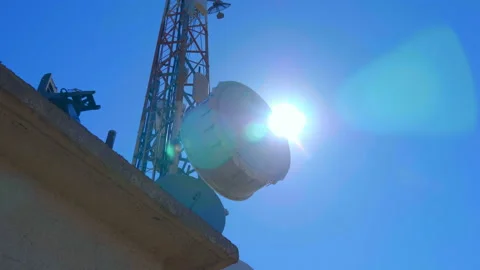High telecommunication tower standing on top of a mountain against the blue sky  Stock Footage 104065325