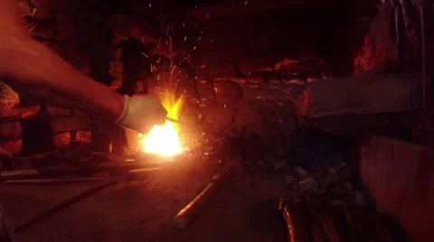 High temperature sparkling little flame, hand blacksmith throws fuel Stock Footage 46419524