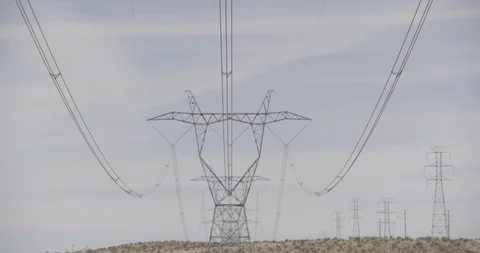 High Tension Power Lines and Tower in Desert Stock Footage 89942632