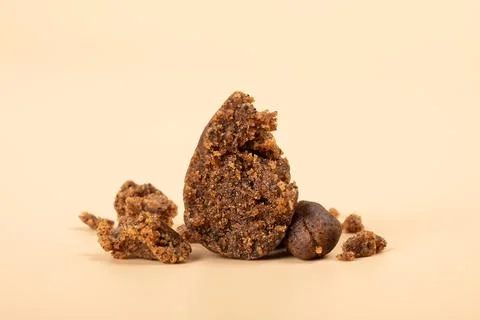 High thc extract, crumbled cannabis hashish slices on beige background Фото