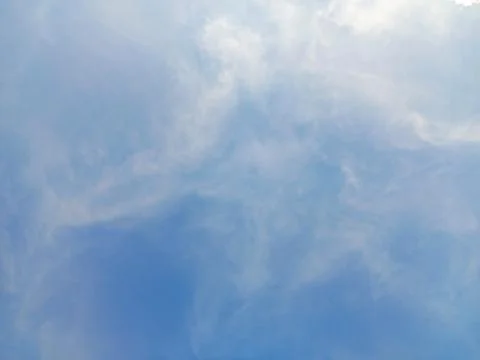 A high thin white cirrus clouds isolated on blue sky. Angelic clouds. Stock Photos