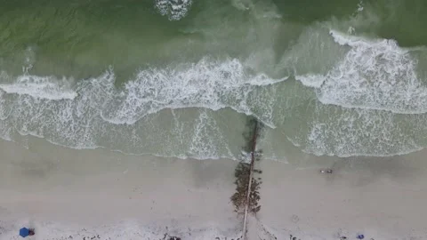 High top down aerial shot of a beach with people walking ending over a lifegu Stock Footage 138518287