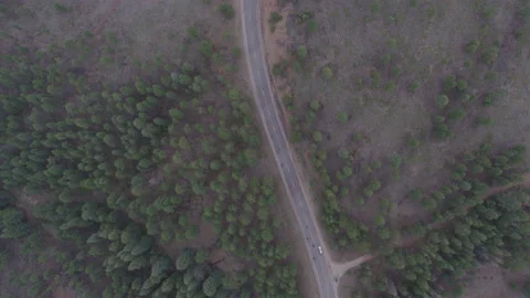 High top down aerial of traffic on curvy forested mountain pass in Colorado Stock Footage 233754510