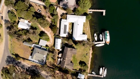 High Top Down Aerial View of Lake and Lake Houses in Small Town with boats piers Stock Footage 99019842