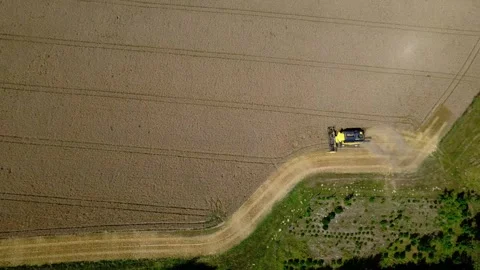 High top down view of a combine harvester and lines in a wheat field Stock Footage 340462667
