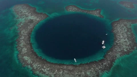 High top drone view yachts inside Great Blue Hole giant marine sinkhole Belize Stock Footage 204853328